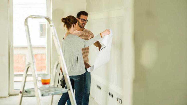 Couple painting their living room.